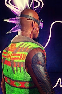 a man in a neon vest is standing in front of a neon light