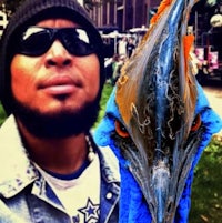 a man with a blue bird on his head